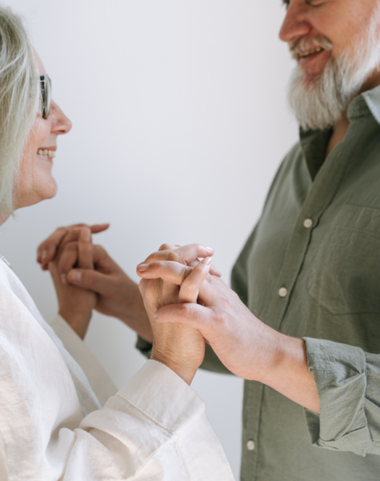Baby Boomer couple embracing hands