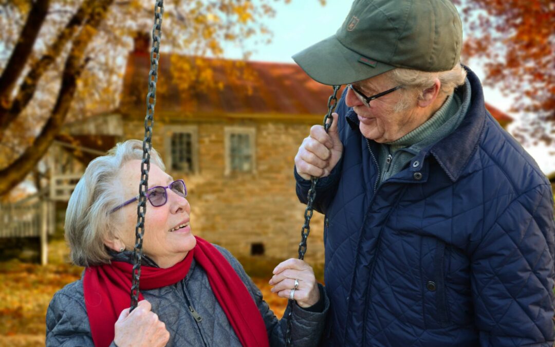Elderly couple sitting on swing talking about retirement