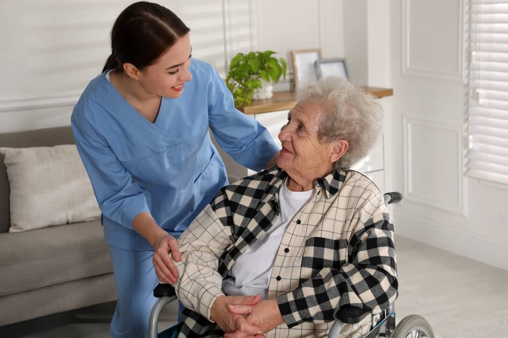Nurse with patient in wheelchair evaluating their health